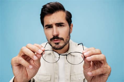 Close Up Portrait Of A Brunette Man Looking Through Glasses That He
