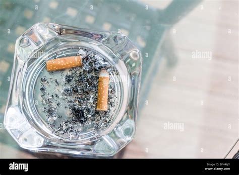 cigarette in an ashtray glass Stock Photo - Alamy