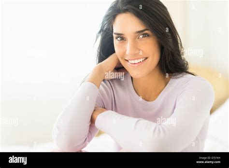 Woman Sitting On Bed Stock Photo Alamy