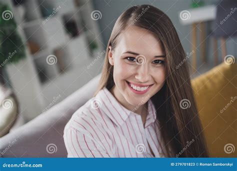 Photo Of Adorable Shiny Young Lady Dressed Striped Shirt Sitting Sofa