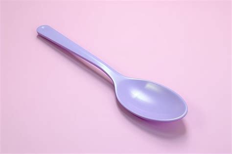 Premium Ai Image A Purple Spoon On A Pink Surface