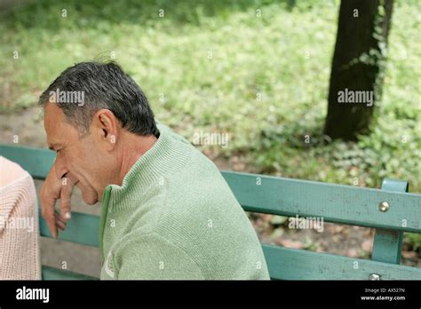 Mature Man Sitting On A Bench Stock Photo Alamy