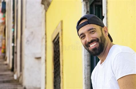 Portrait Of A Spanish Man With Snapback Hat Looking Camera Stock Photo