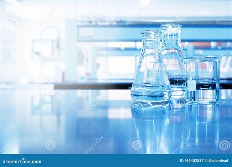 Water In Beaker And Flask Glass In Chemistry Blue Science Laboratory Background Stock Image