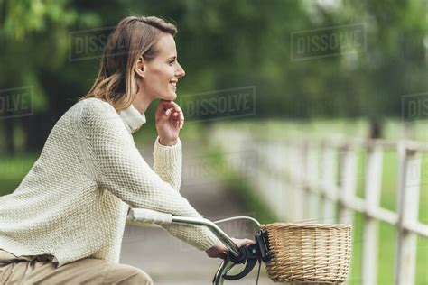Attractive Smiling Blonde Woman Sitting On Bicycle Royalty Free Stock
