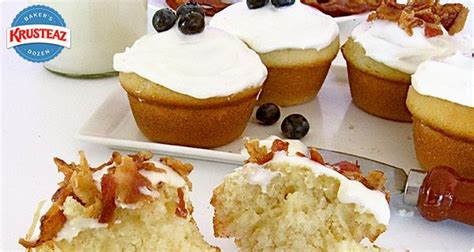 Cupcakes With White Frosting And Blueberries On A Plate