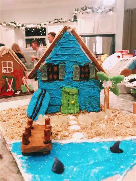 A Gingerbread House Made To Look Like It Is Floating In The Water With