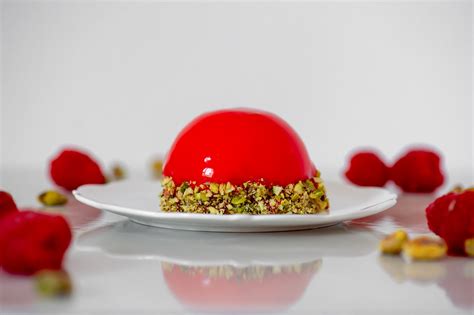 White Chocolate Mousse Domes With Raspberry Gel Pistachio Sponge And A