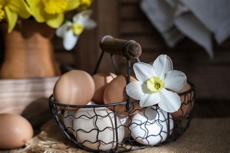 Premium Photo A Basket Of Eggs And A Vase Of Daffodils Easter Still