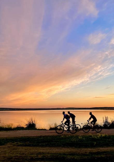 Premium Photo Silhouette Of A Couple Riding Bicycles At Sunset On The