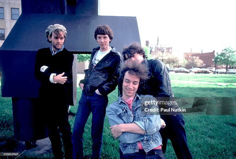 Portrait of the band REM posing outdoors next to a sculpture at Park ...