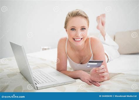 Natural Cheerful Blonde Holding Credit Card And Looking At Camera Stock