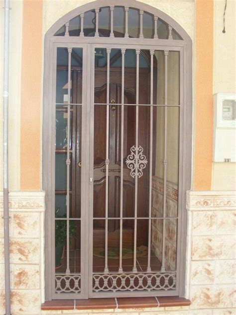 An Arched Glass Door With Decorative Iron Work