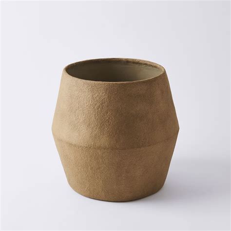 A Brown Vase Sitting On Top Of A White Table