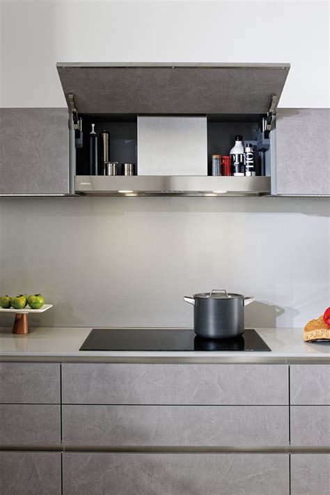 A Stove Top Oven Sitting Inside Of A Kitchen Next To A Wall Mounted Pot