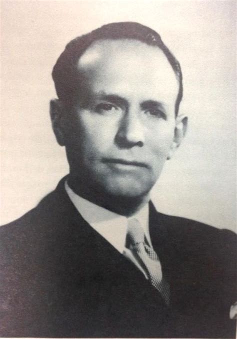 An Old Photo Of A Man In A Suit And Tie