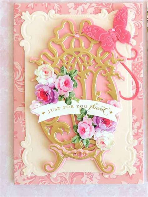 A Pink And Gold Card With Flowers On It