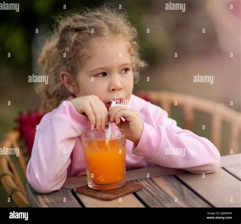 Cute Girl Drinking Juice Stock Photo Alamy