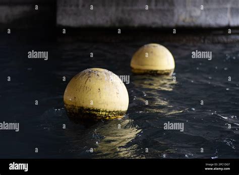 Yellow Plastic Buoy Or Buoys Floating On A Lake Water In Switzerland