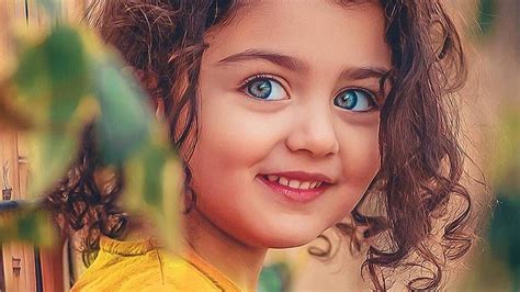 Smiley Curly Hair Blue Eyes Cute Girl In Blur Background Wearing Yellow