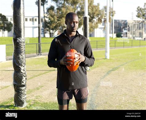 Rugby Player Holding Ball On Field Stock Photo Alamy