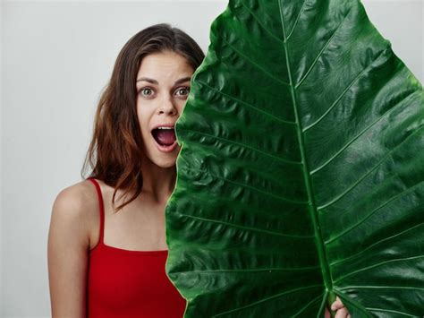 Premium Photo Woman In Red Swimsuit With Open Mouth Palm Leaf Cropped