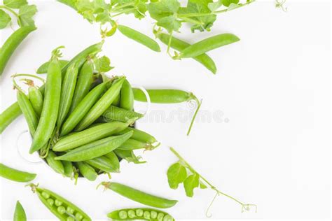 Fresh Organic Raw Green Peas Pods In A Bowl With Peas Nd Plants Leaves