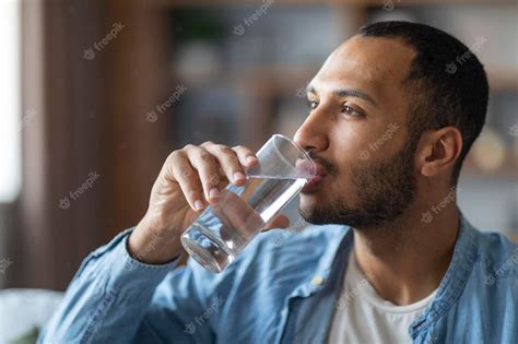 Premium Photo Portrait Of Handsome Young Black Man Drinking Water