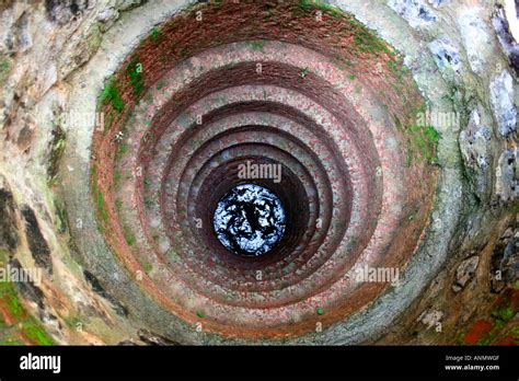 A view of the water seen at the bottom of a well Stock Photo - Alamy