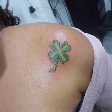 A Woman With A Shamrock Tattoo On Her Shoulder