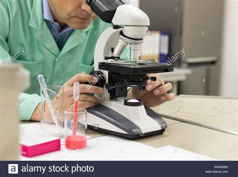 Close Up Of A Male Scientific Researcher Using Microscope In The