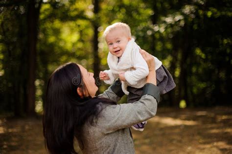 Happy Brunette Mother Playing With A Smiling Baby Daughter Stock Image
