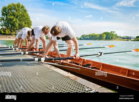 Teamwork Concept Of Men Rowing Team Mounting Boat In Coordination Stock