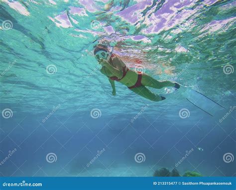 Young Woman In Red Bikini Freediver Gliding Underwater Over Vivid Coral