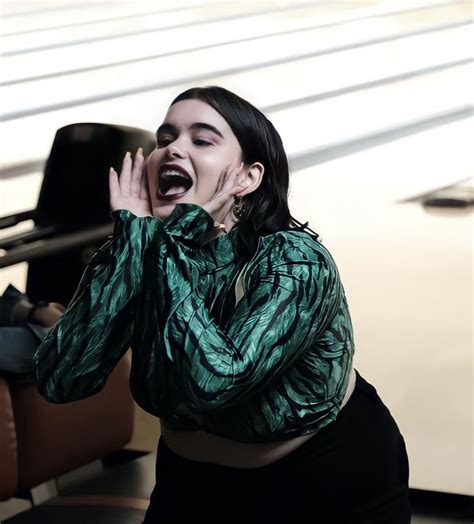 A Woman With Her Mouth Open Standing Next To A Bowling Alley