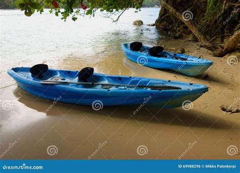 Blue Canoes On The Shore Of The Bow River In Banff National Park Stock