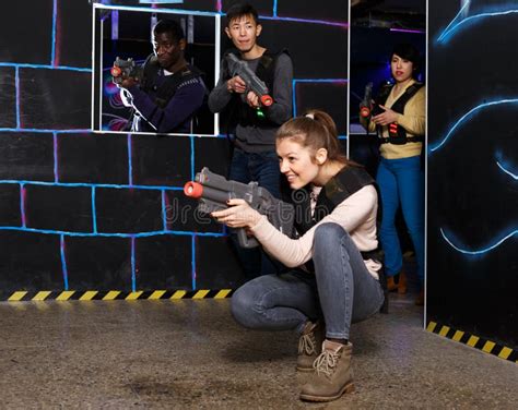 Emotional Girl with Laser Pistol Playing Laser Tag with Multinational ...