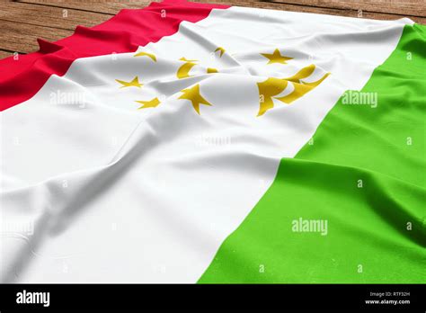 Flag Of Tajikistan On A Wooden Desk Background Silk Tajik Flag Top