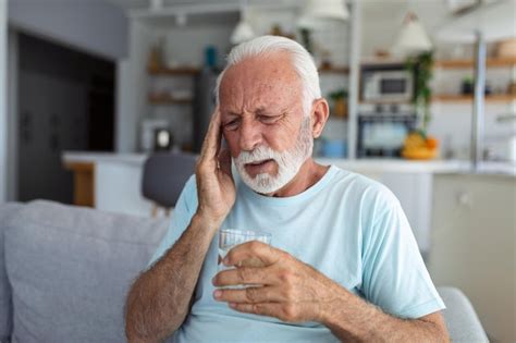 Premium Photo Senior Man Suffering From A Headache At Home Worried