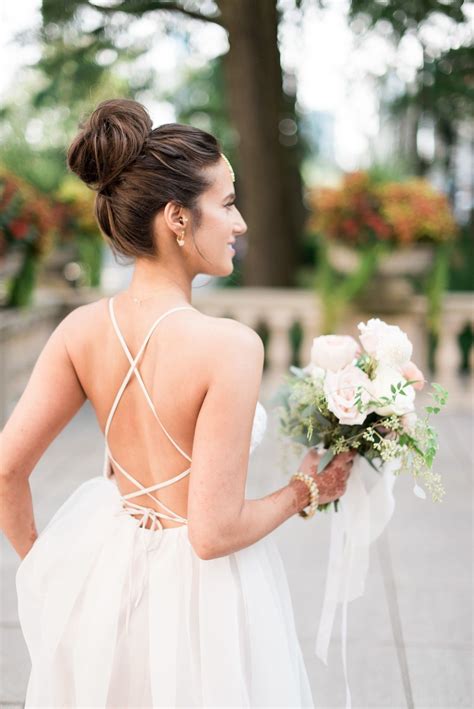 Bride With Top Knot And Backless Dress Wedding Hairstyles Updo