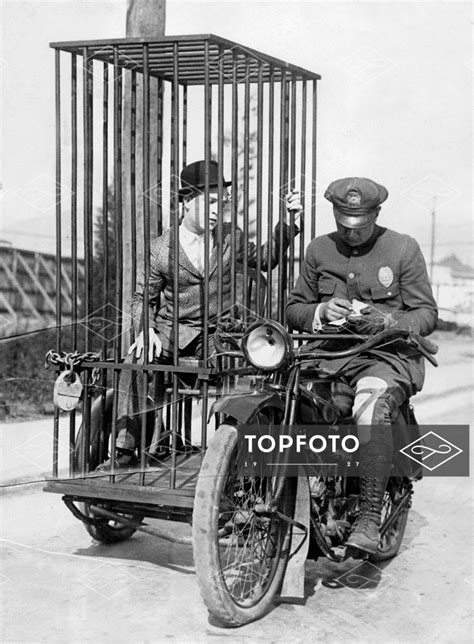 A Policeman Transports A Prisoner In A Cage On The Sidecar Of His