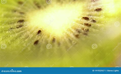 Closeup Of Fresh Kiwis Slices Falling Into Clear Water With Big Splash