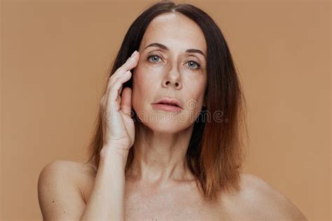 Portrait Of Female With Short Hair Isolated On Beige Stock Image