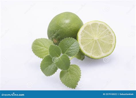 Green Limes Cut In Half And Whole Fresh Mint Isolated On A White