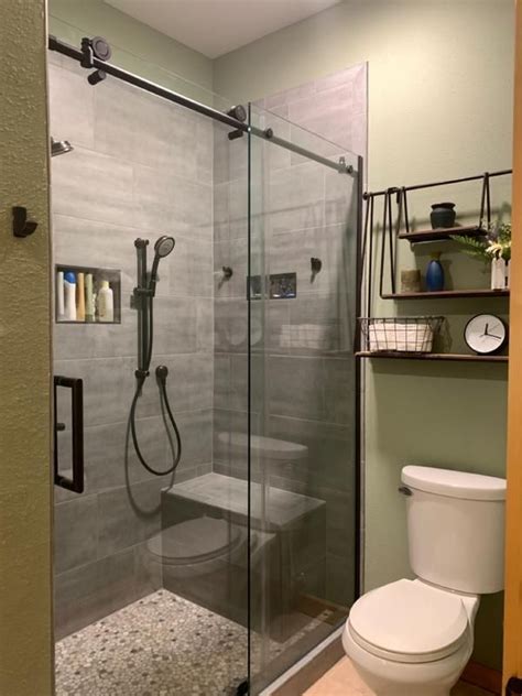 A Bathroom With A Glass Shower Door And Toilet