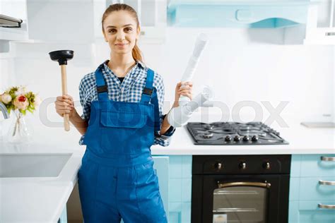 Female Plumber In Uniform Holds Plunger And Pipe Stock Image Colourbox