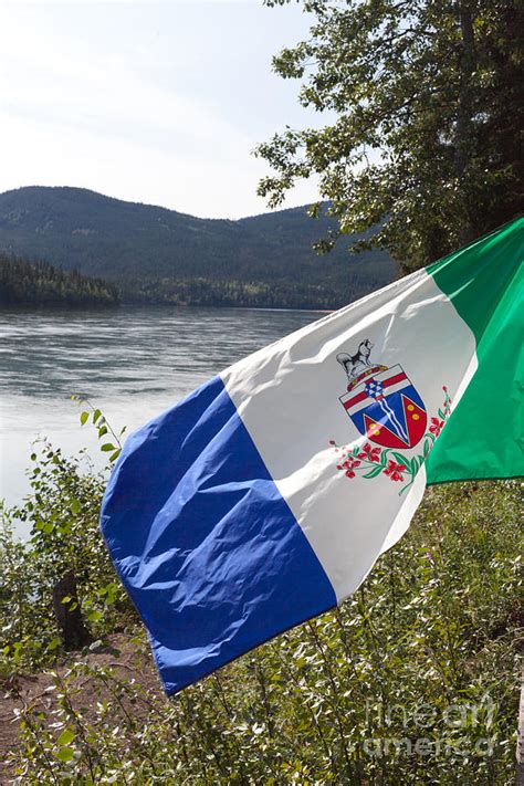 Yukon Flag In Front Of Yukon River Photograph By Stephan Pietzko