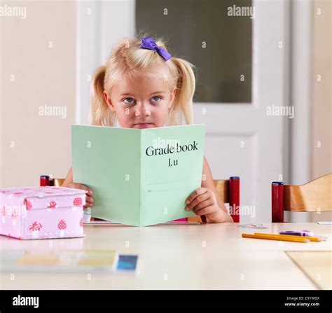 Bored Girl Doing Homework At Desk Stock Photo Alamy