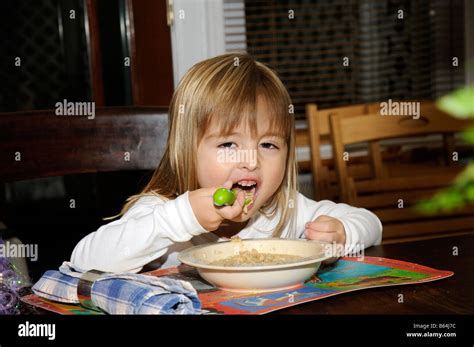 Little girl eating healthy food Stock Photo - Alamy