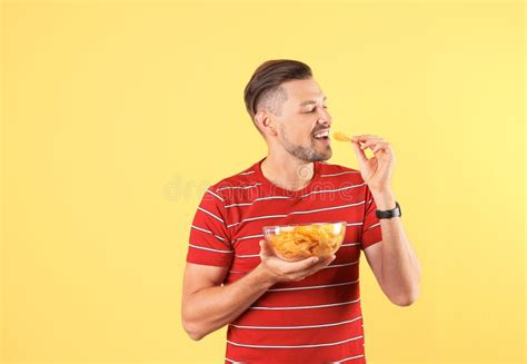 Man Eating Potato Chips On Color Background Stock Photo Image Of